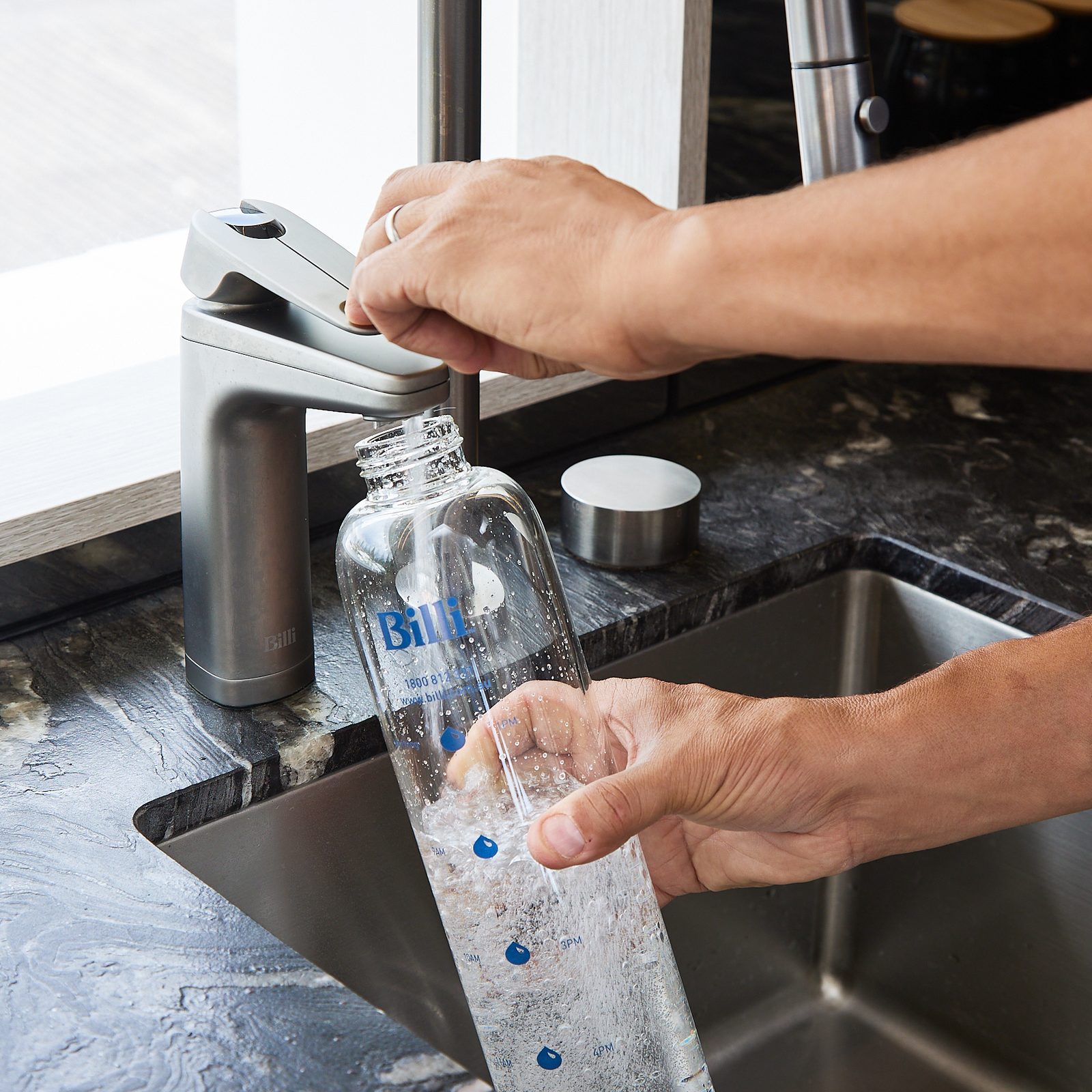 Filling a Billi glass bottle with sparkling water from a Billi XL dispenser