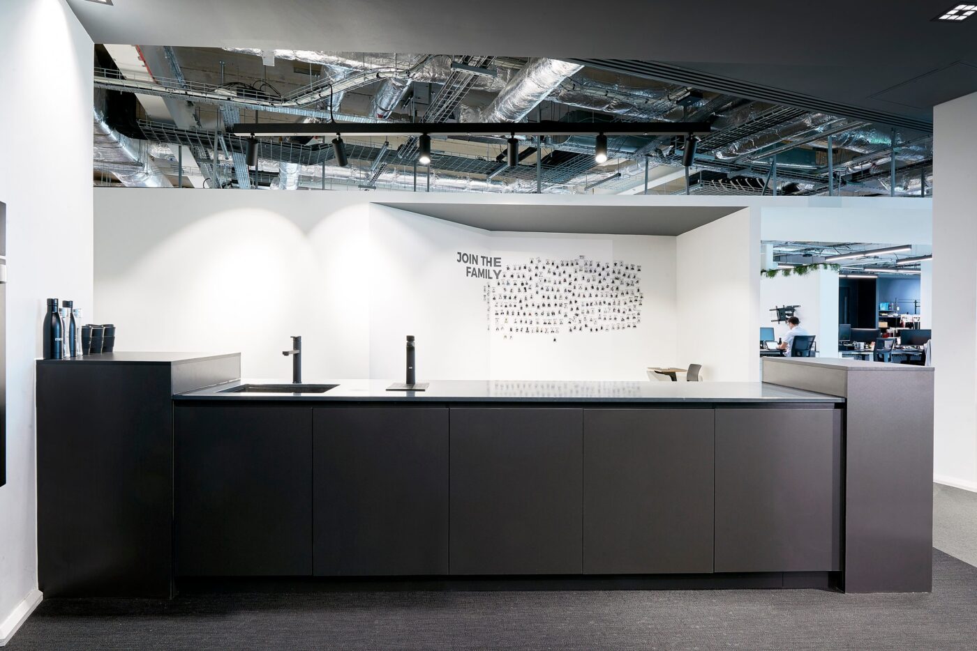 Office kitchen run with Billi dispensers under an exposed services ceiling