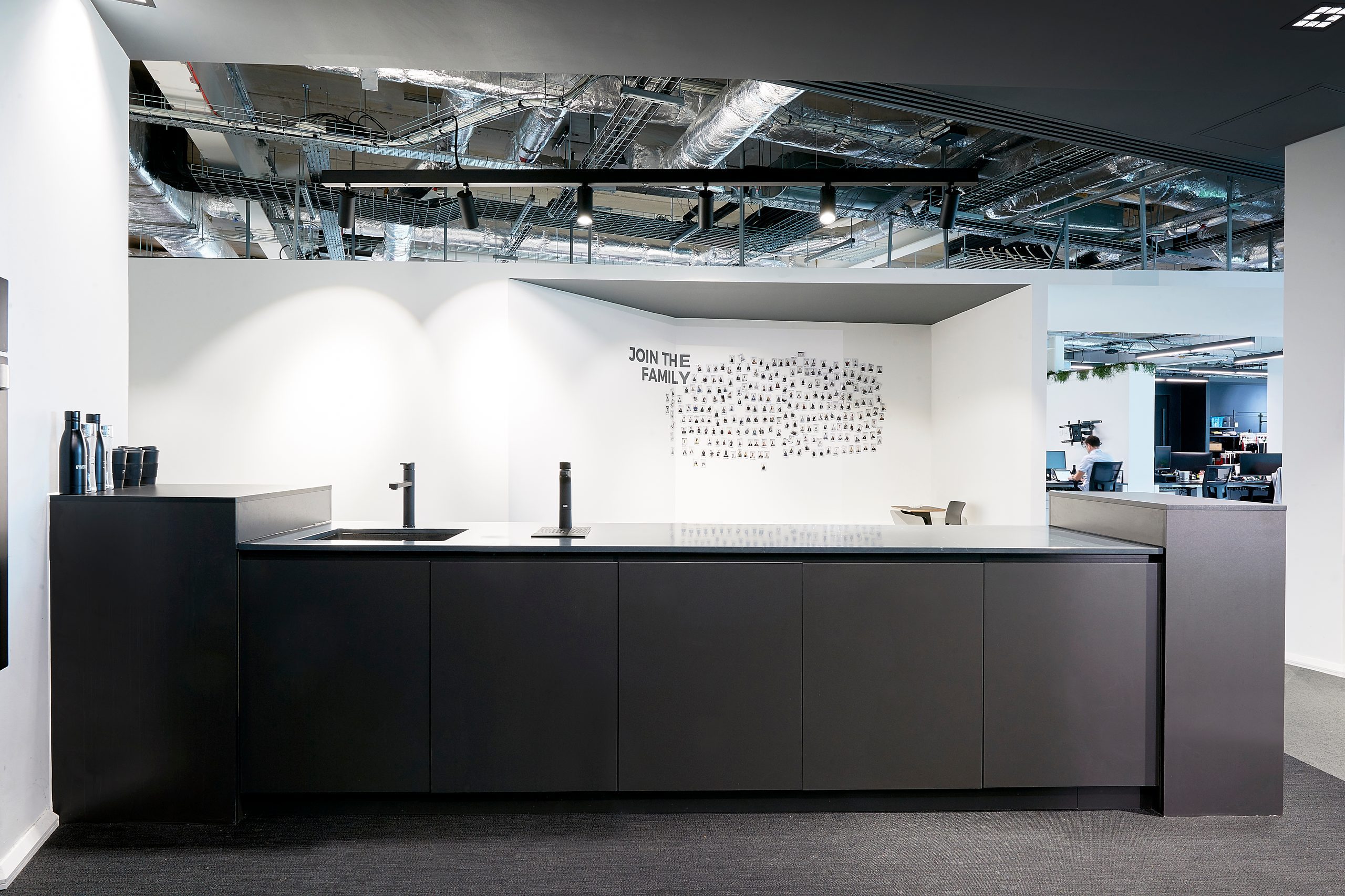 Office kitchen run with Billi dispensers under an exposed services ceiling