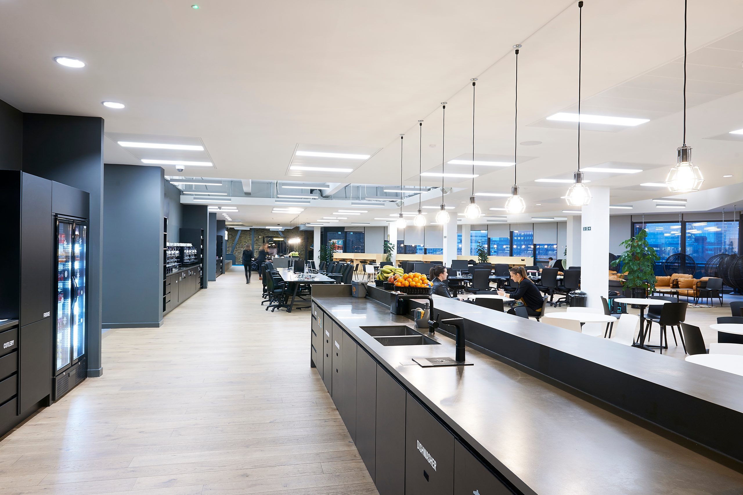 Open-plan office with a long kitchen island and Billi dispensers