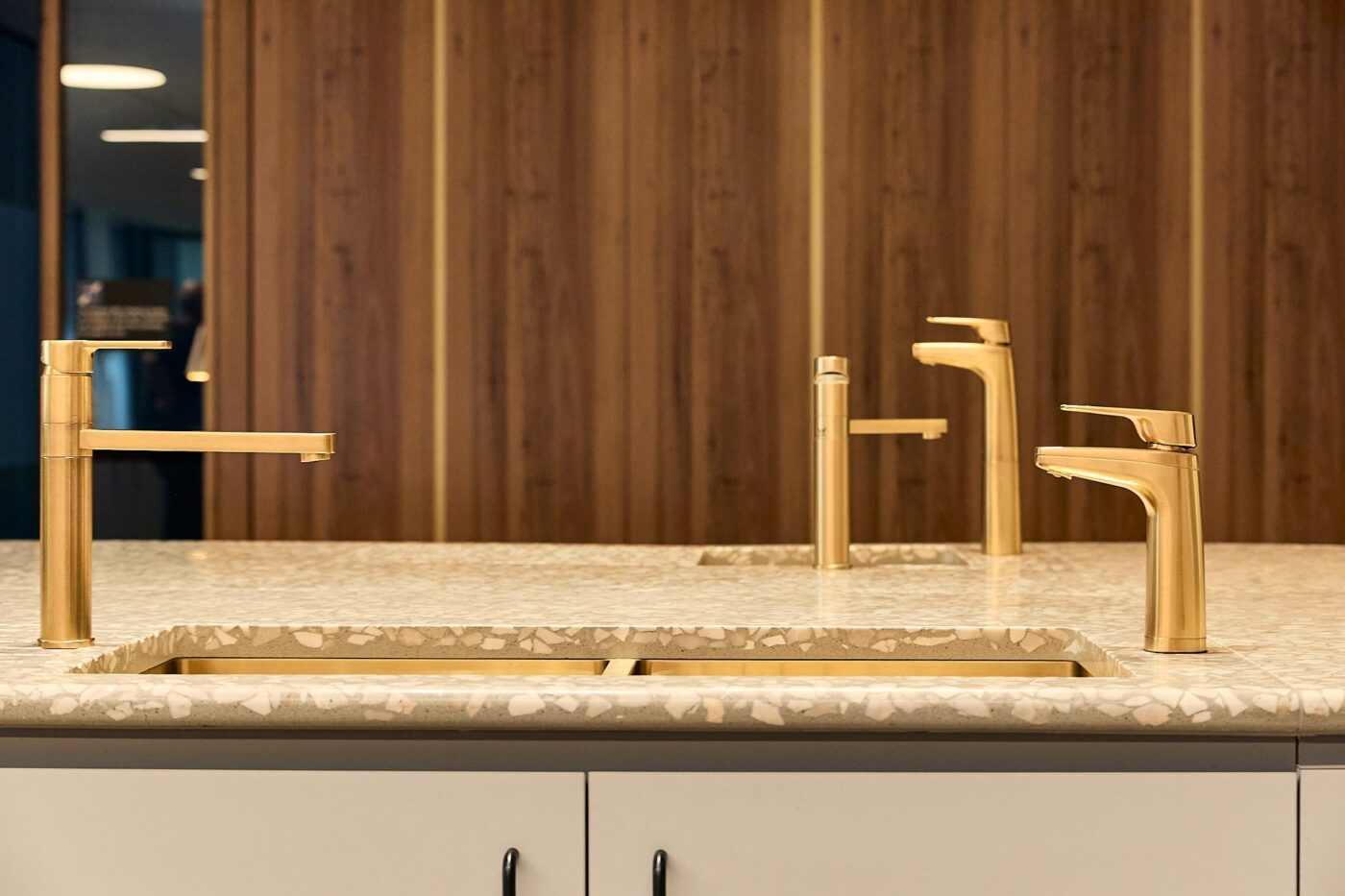 Urban brass Billi XL dispensers and paddle mixers on a terrazzo counter